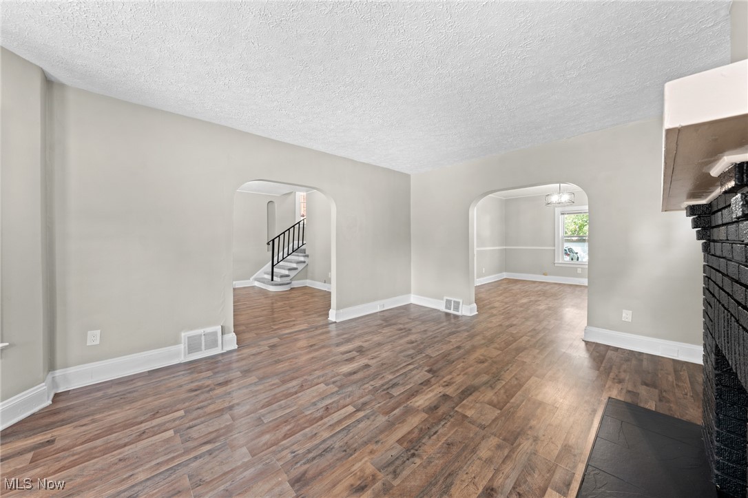 2195 Barrington Road Cleveland, OH 44118 - Photo 18 of 50 Unfurnished living room with a fireplace, wood-type flooring, and a textured ceiling