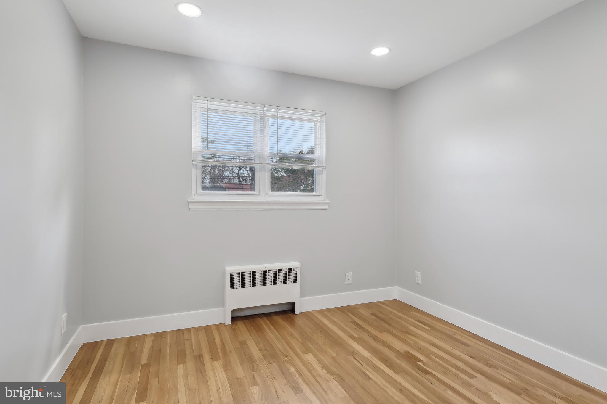 904 Big Oak Road Yardley, PA 19067 - Photo 11 of 56 a view of an empty room with wooden floor and a window