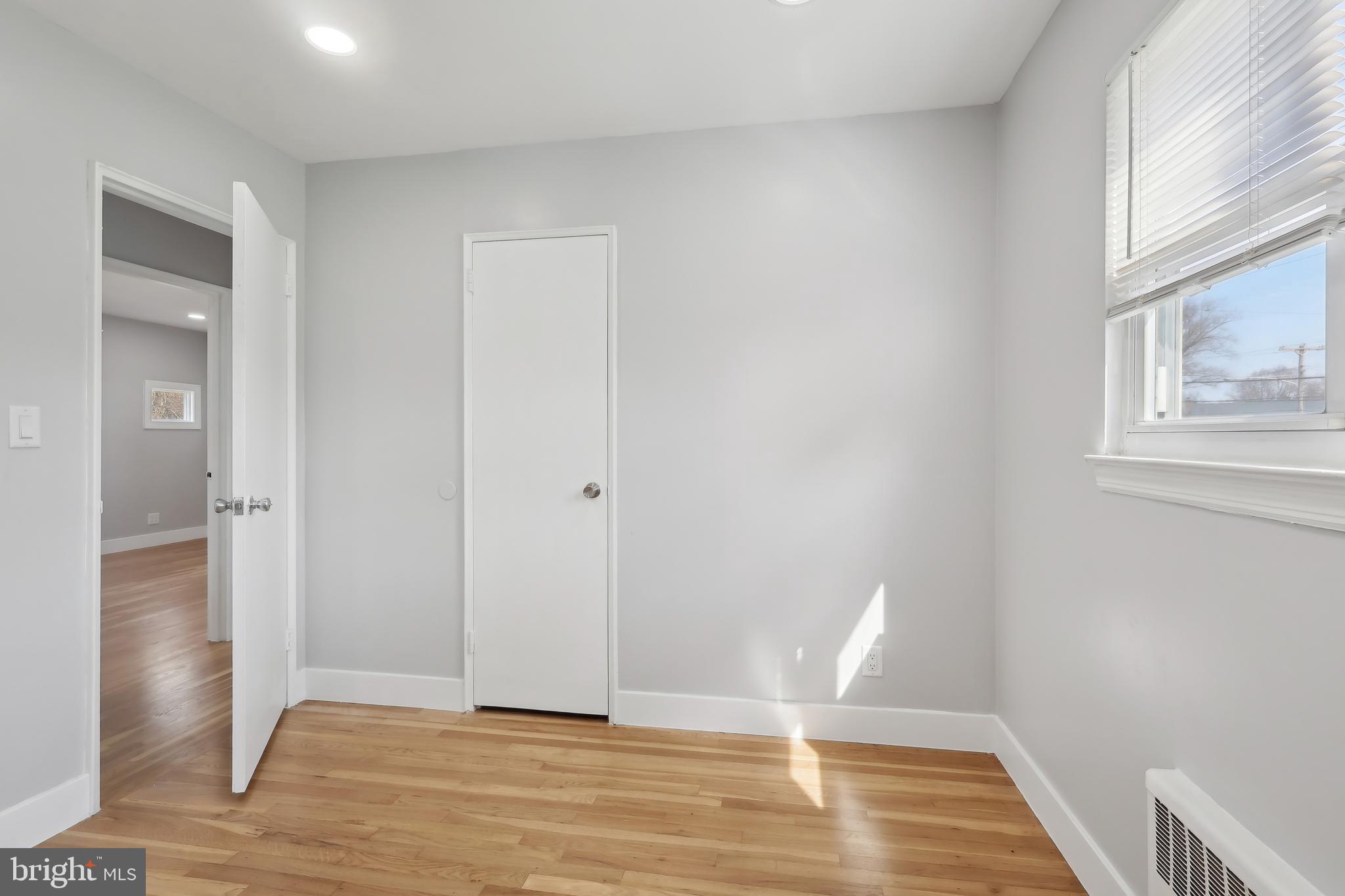 904 Big Oak Road Yardley, PA 19067 - Photo 12 of 56 a view of an empty room with wooden floor and a window