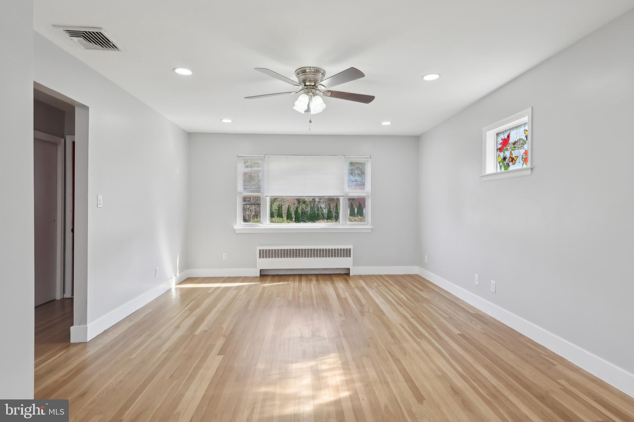 904 Big Oak Road Yardley, PA 19067 - Photo 15 of 56 a view of an empty room with a window and wooden floor