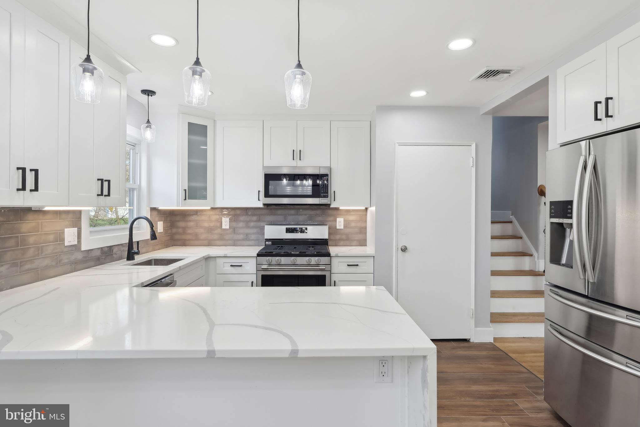 904 Big Oak Road Yardley, PA 19067 - Photo 18 of 56 a kitchen with kitchen island a white counter top space stainless steel appliances and cabinets