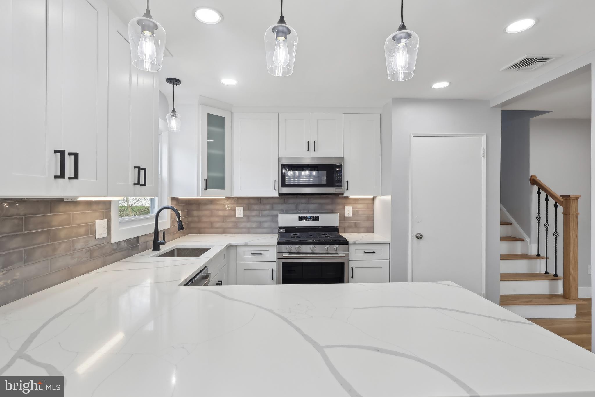 904 Big Oak Road Yardley, PA 19067 - Photo 23 of 56 a large kitchen with stainless steel appliances granite countertop a refrigerator and a stove top oven
