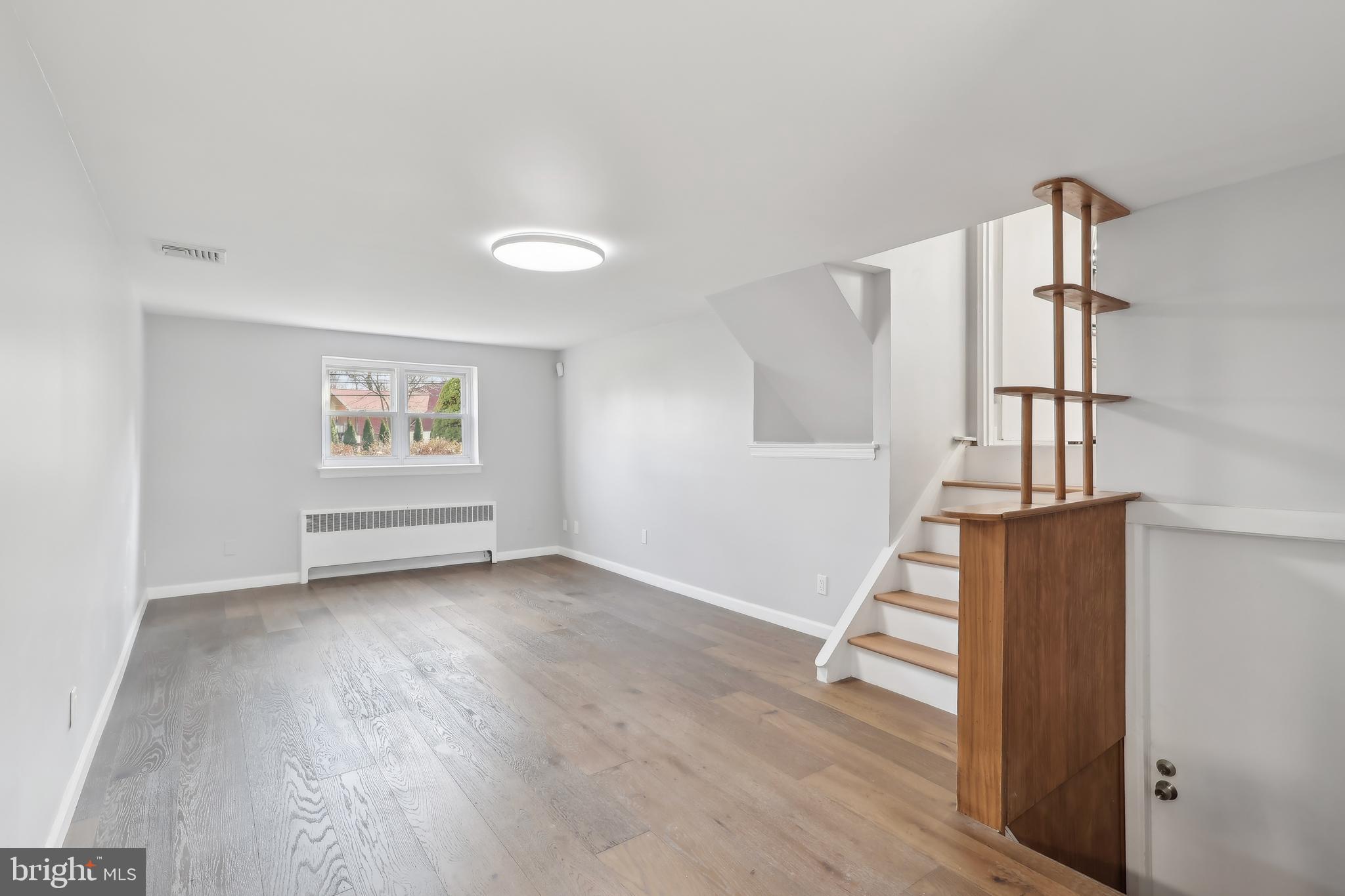 904 Big Oak Road Yardley, PA 19067 - Photo 33 of 56 an empty room with wooden floor and white walls