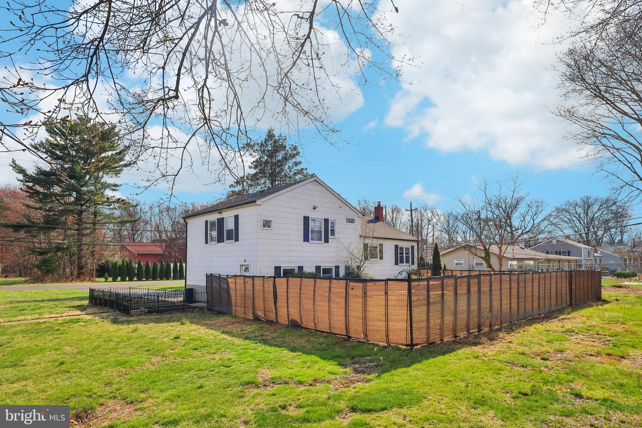 904 Big Oak Road Yardley, PA 19067 - Photo 36 of 56 a front view of a house with a yard fountain and a large tree