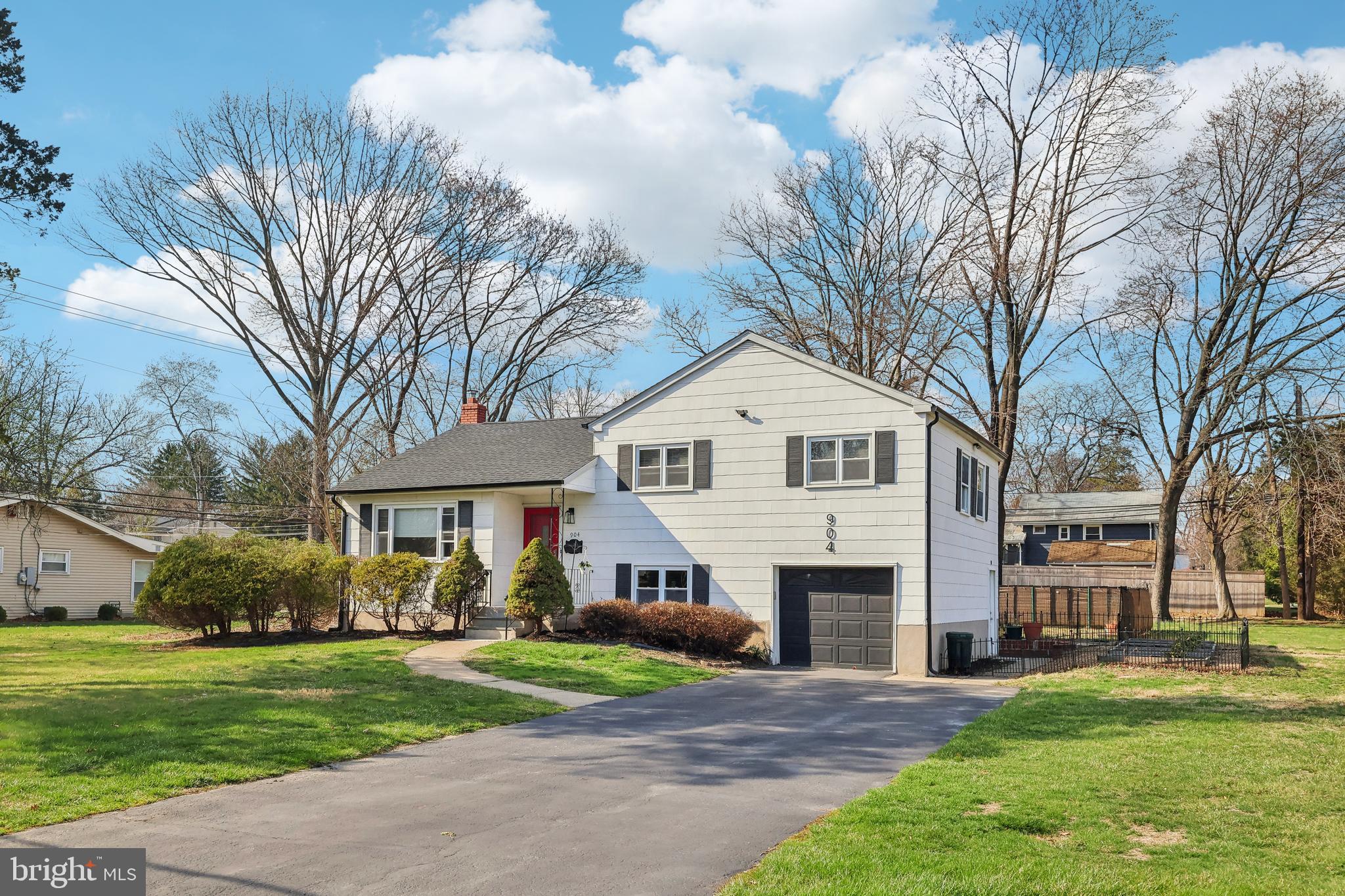 904 Big Oak Road Yardley, PA 19067 - Photo 4 of 56 a front view of a house with a yard and garage
