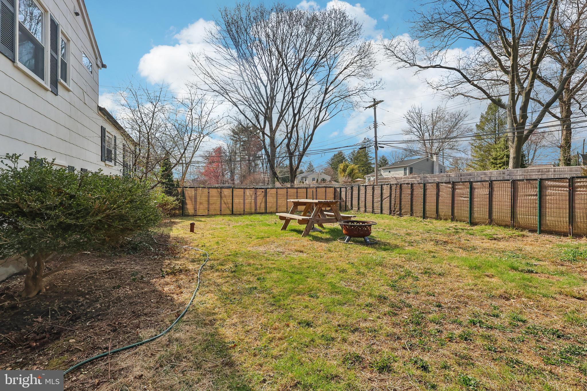 904 Big Oak Road Yardley, PA 19067 - Photo 42 of 56 a view of backyard with wooden fence and large trees
