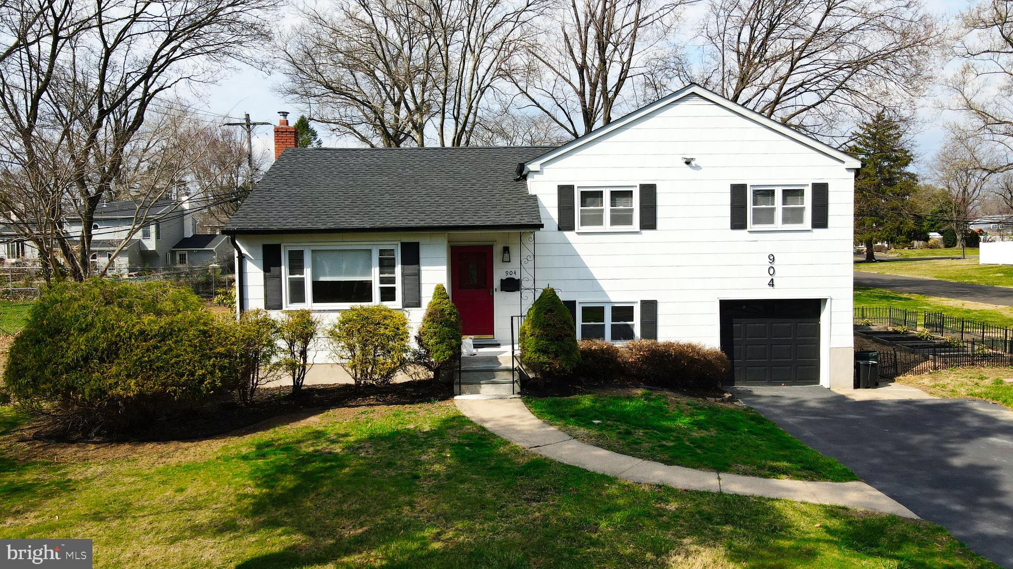 904 Big Oak Road Yardley, PA 19067 - Photo 50 of 56 a front view of a house with a yard and porch