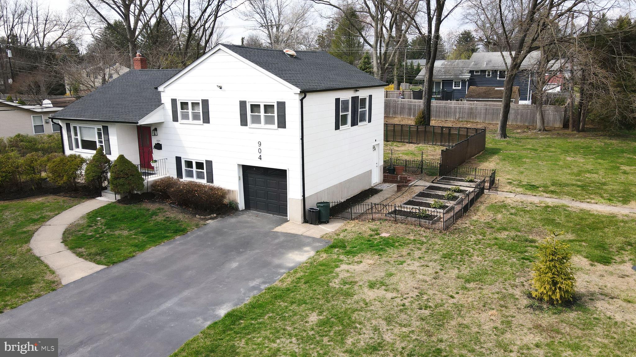 904 Big Oak Road Yardley, PA 19067 - Photo 54 of 56 a view of a white house with a yard and large trees