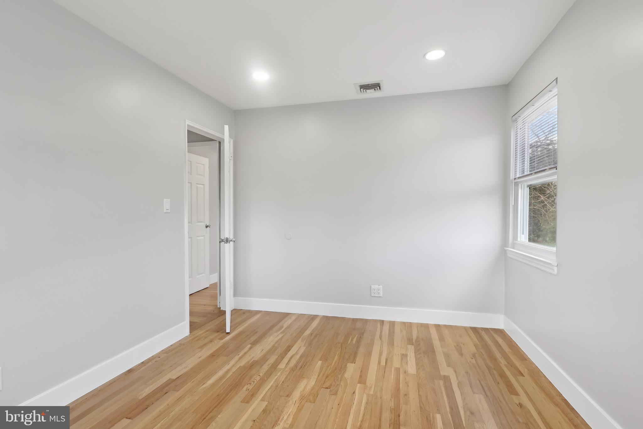 904 Big Oak Road Yardley, PA 19067 - Photo 10 of 56 an empty room with wooden floor and windows