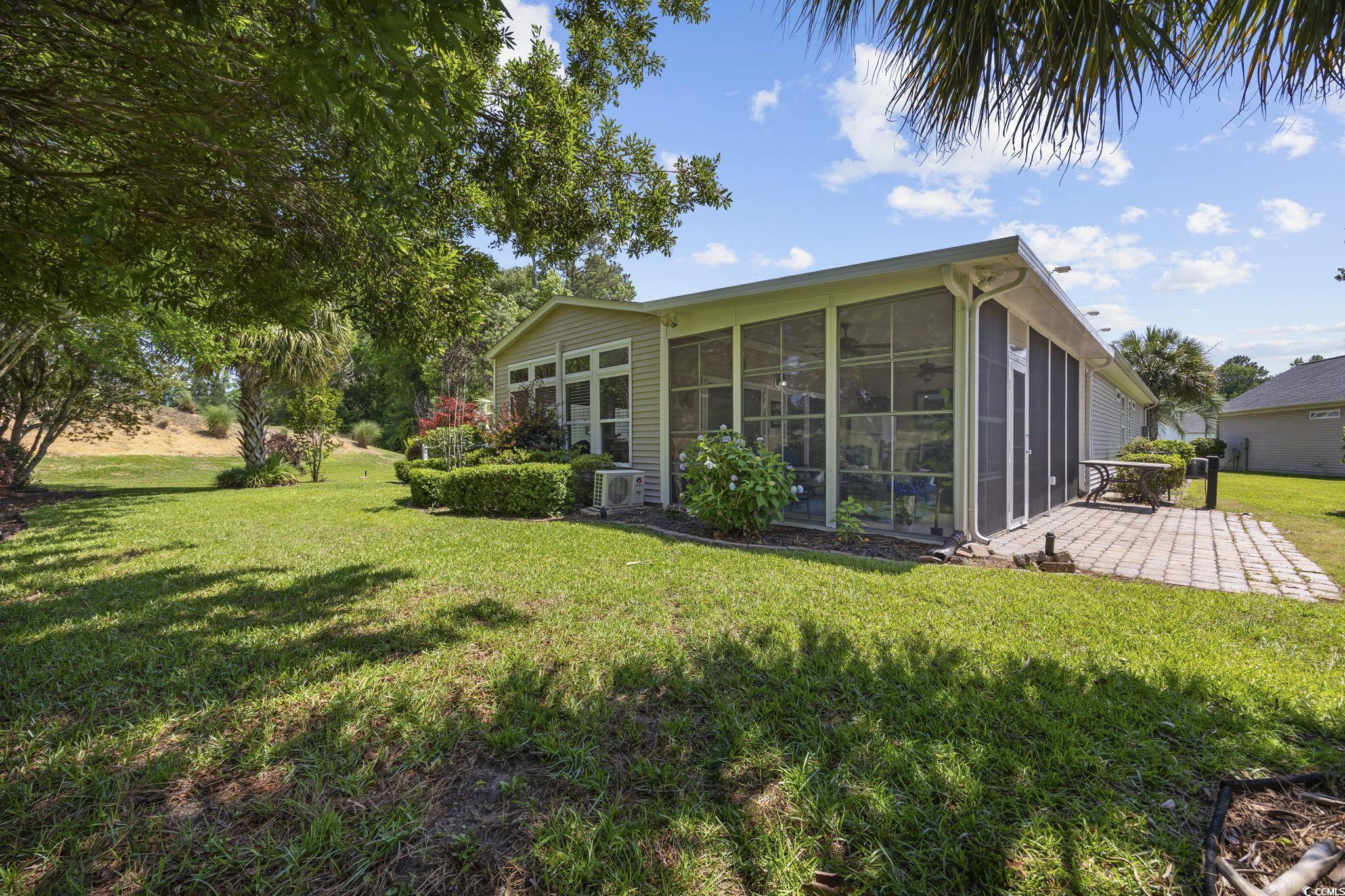 7005 Wellesly Court Murrells Inlet, SC 29576 - Photo 35 of 40 Rear view of property with a sunroom, a lawn, and