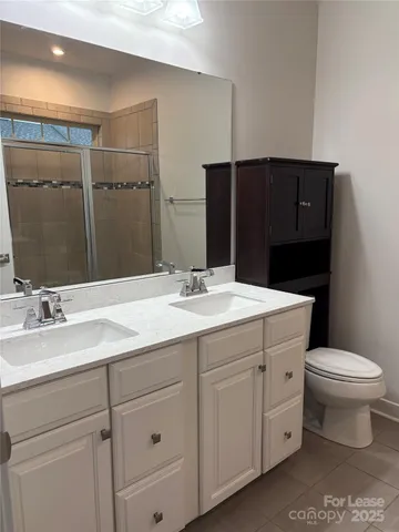 a bathroom with a glass shower door