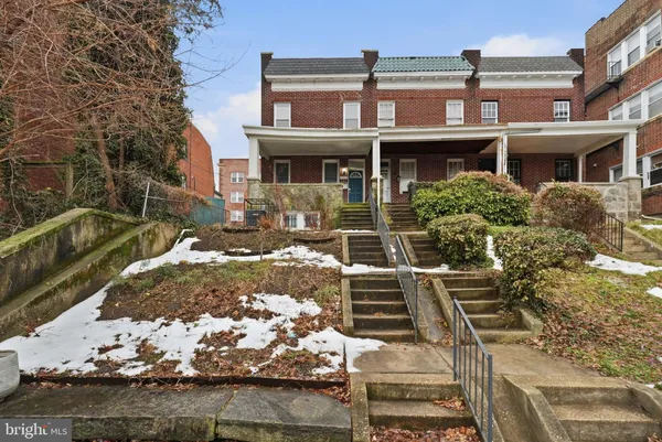 a view of a brick house with many windows
