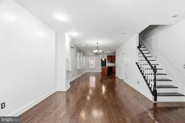 a view of a room with wooden floor and stairs