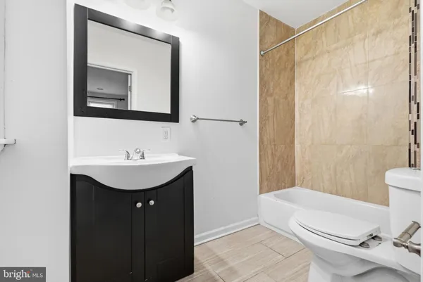 a bathroom with a sink a toilet and bathtub