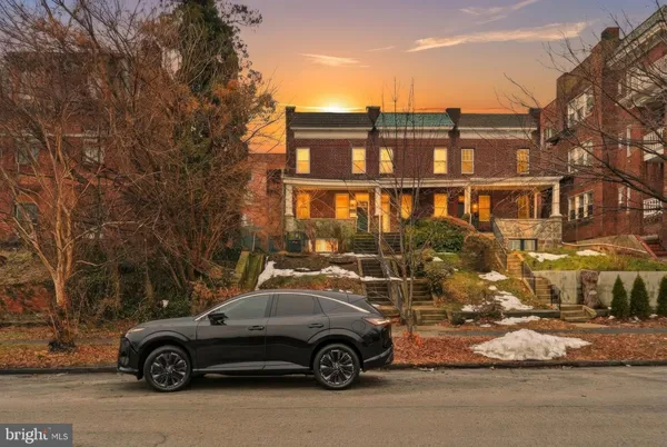 a picture of a bench in front of a wall