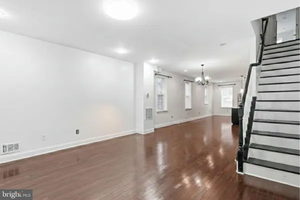 an empty room with a window and a ceiling fan