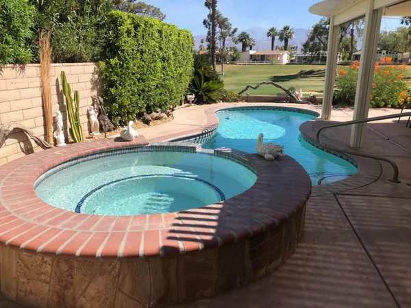 a view of a swimming pool with a patio