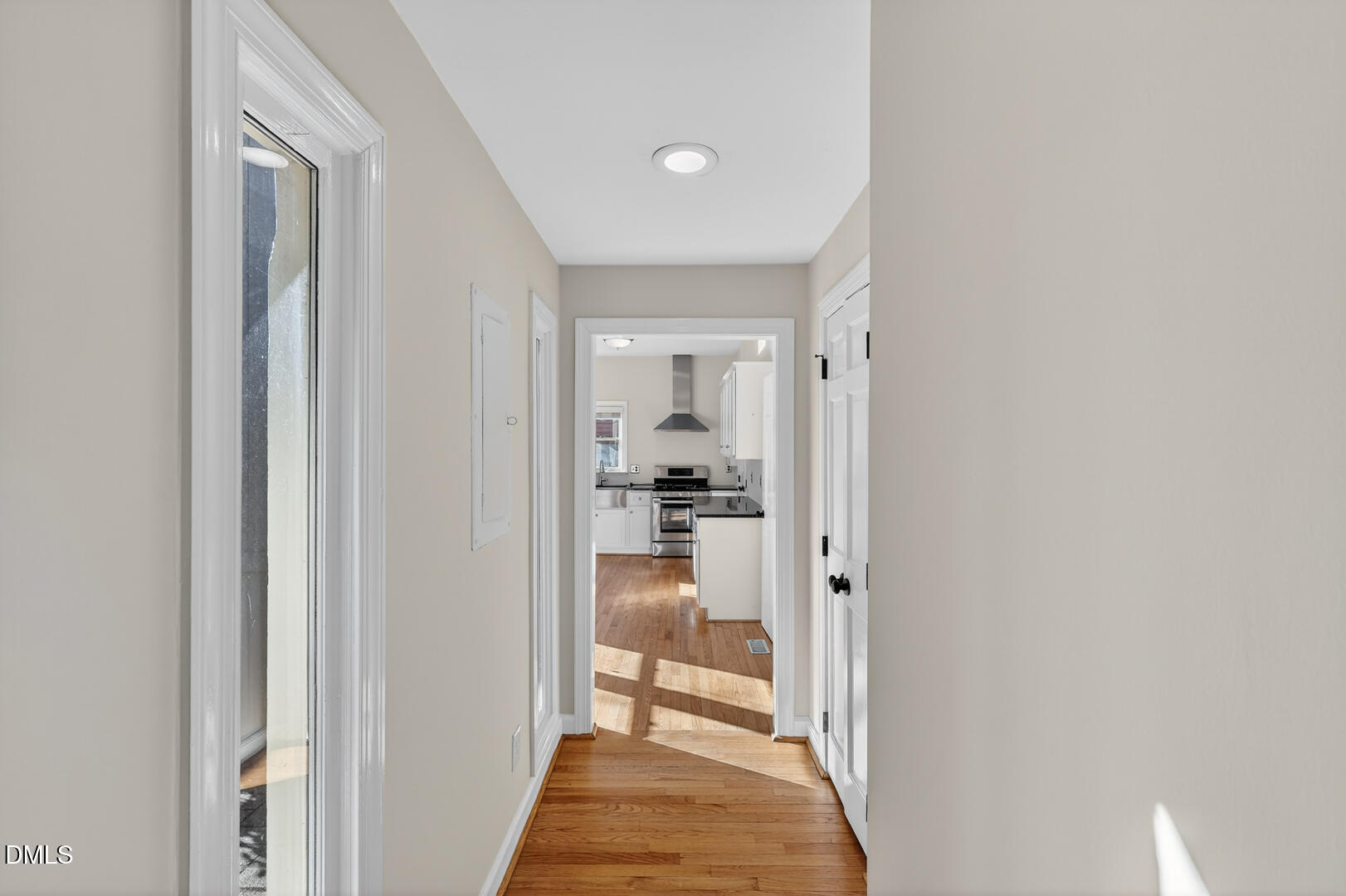 1707 Falls Church Road Raleigh, NC 27609 - Photo 28 of 64 a view of a hallway with a livingroom and a bathroom with bathtub