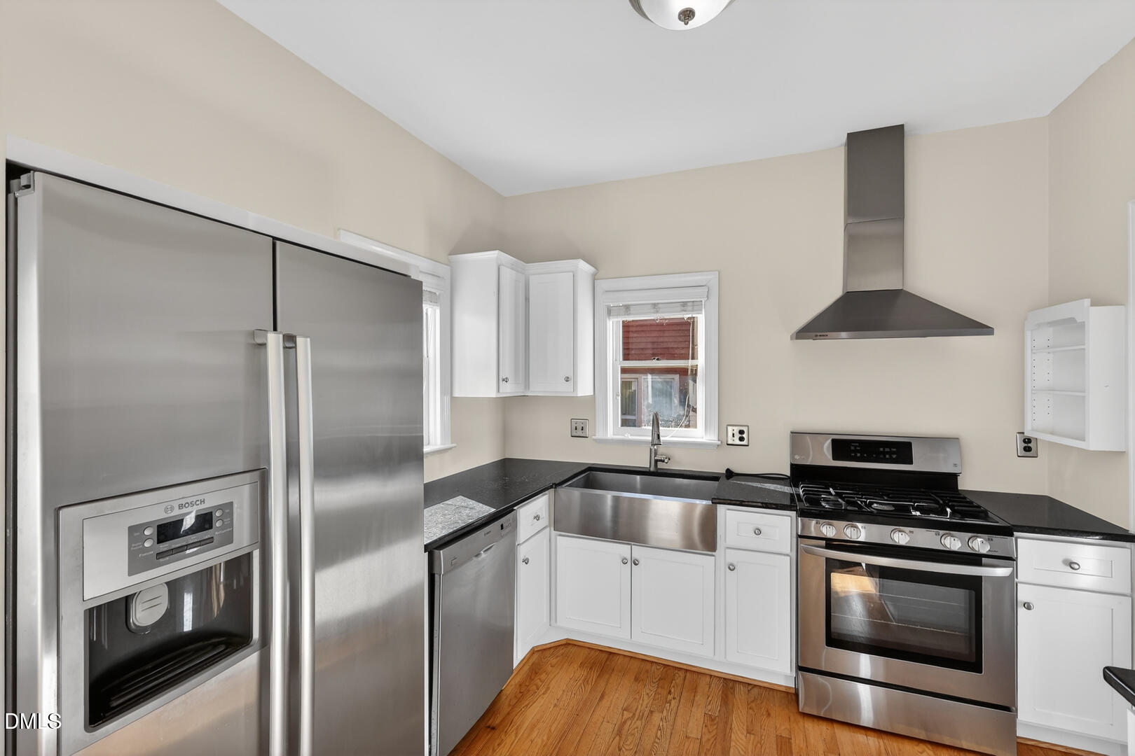 1707 Falls Church Road Raleigh, NC 27609 - Photo 31 of 64 a kitchen with granite countertop a refrigerator and a sink