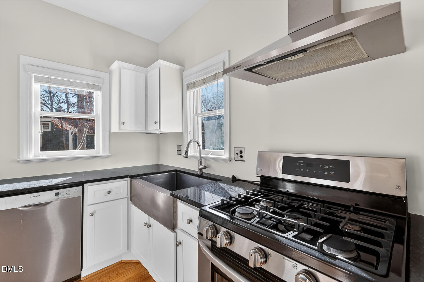 1707 Falls Church Road Raleigh, NC 27609 - Photo 32 of 64 a kitchen with granite countertop a stove and a sink
