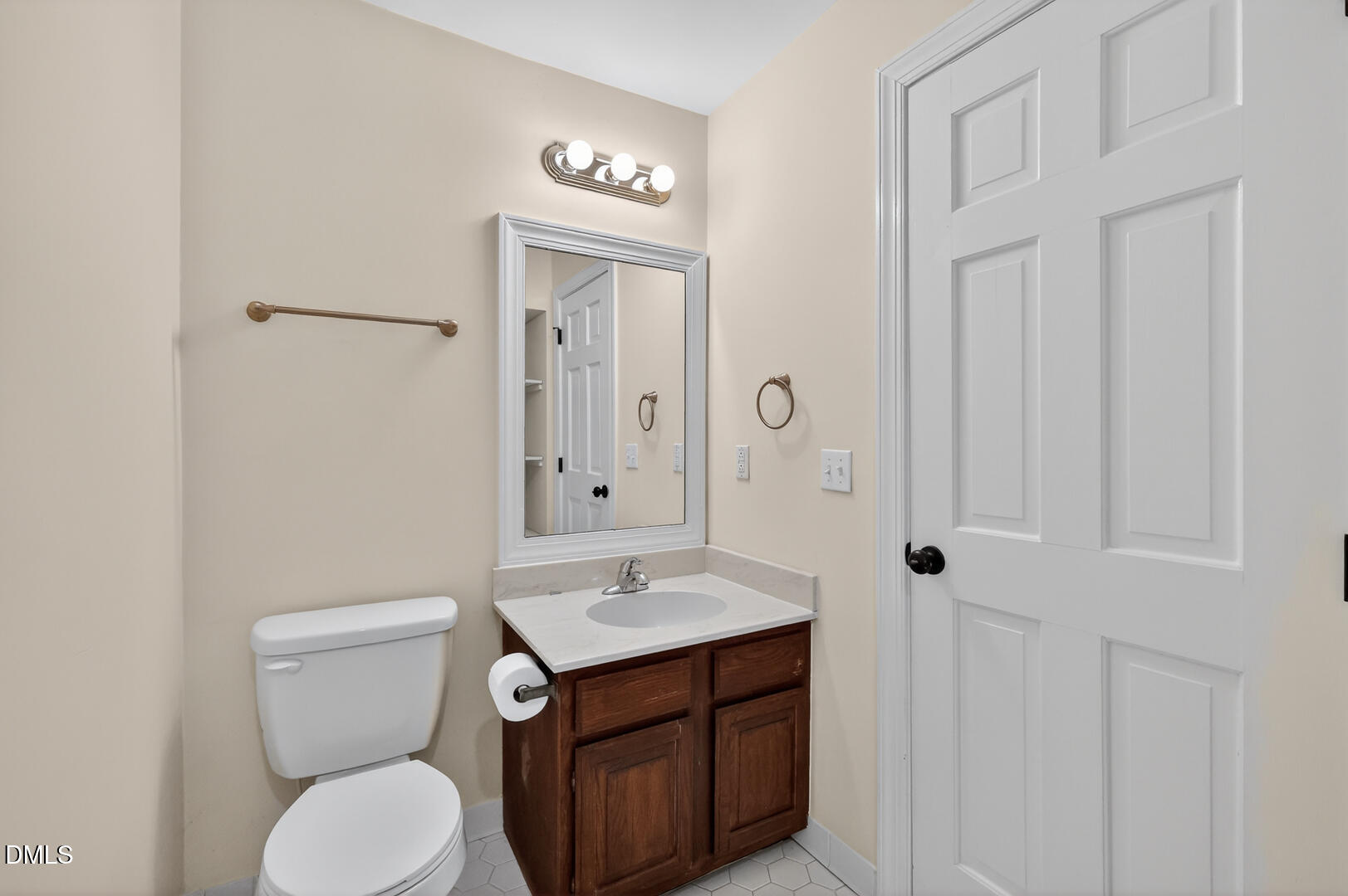 1707 Falls Church Road Raleigh, NC 27609 - Photo 39 of 64 a bathroom with a toilet a sink and mirror