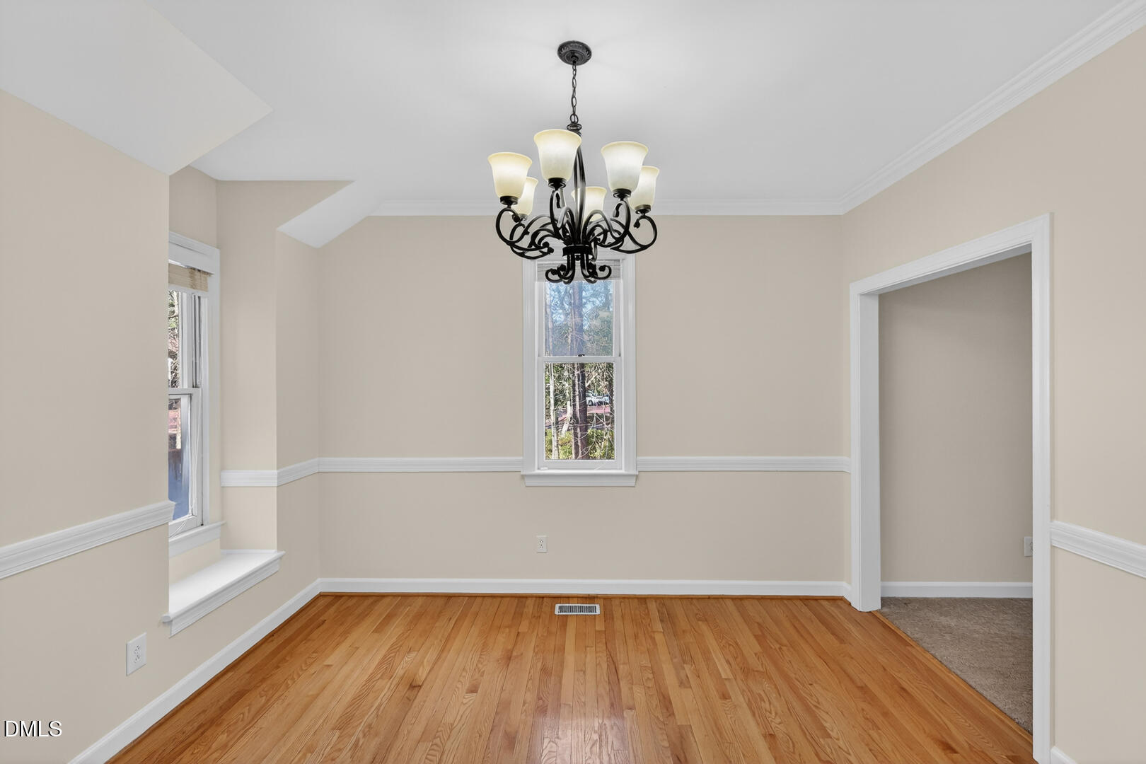 1707 Falls Church Road Raleigh, NC 27609 - Photo 40 of 64 a view of a room with wooden floor and chandelier