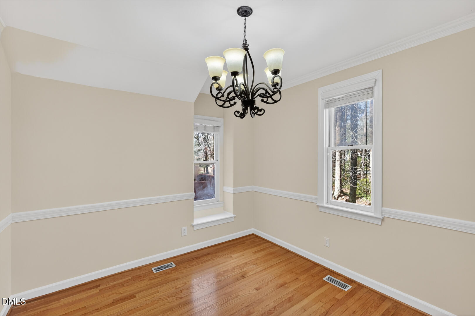 1707 Falls Church Road Raleigh, NC 27609 - Photo 41 of 64 a view of an empty room with wooden floor and a window