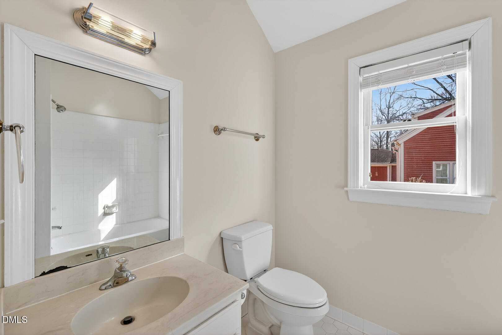 1707 Falls Church Road Raleigh, NC 27609 - Photo 50 of 64 a bathroom with a toilet a sink and a mirror