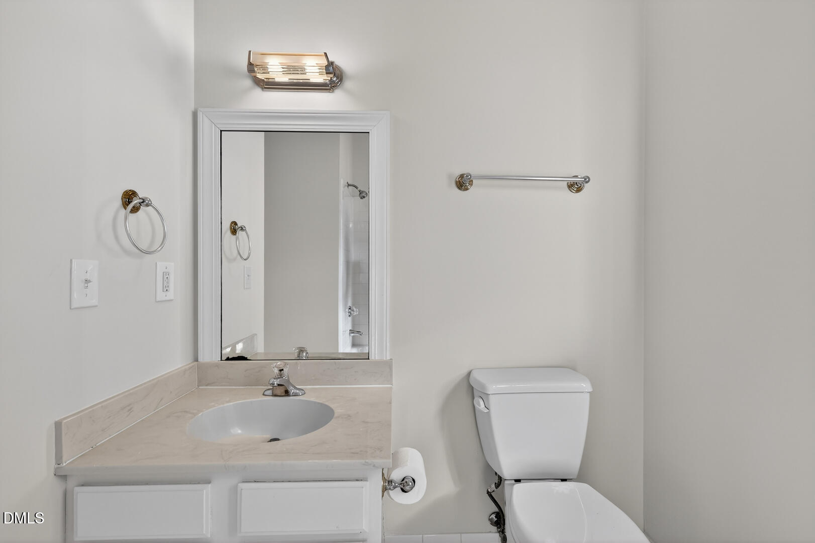 1707 Falls Church Road Raleigh, NC 27609 - Photo 51 of 64 a bathroom with a toilet sink vanity and mirror