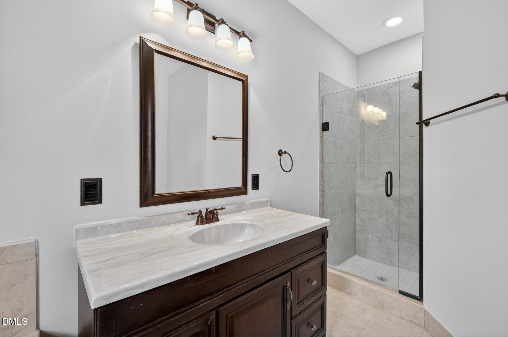 1707 Falls Church Road Raleigh, NC 27609 - Photo 10 of 64 a bathroom with a sink vanity granite shower and a mirror