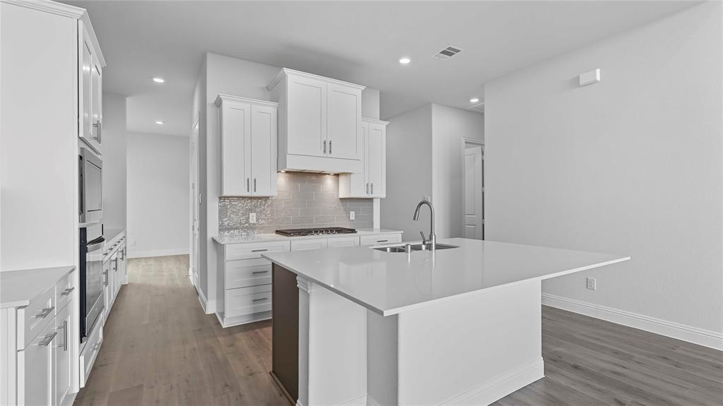 1019 Pitchfork Road Royse City, TX 75189 - Photo 10 of 25 a kitchen with kitchen island a sink stove and refrigerator