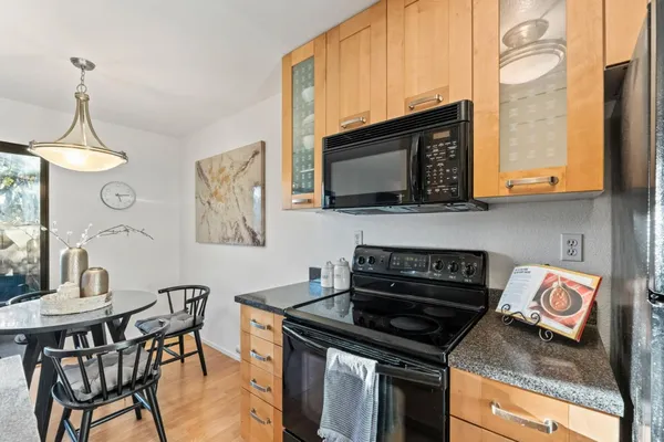 a kitchen with stainless steel appliances granite countertop a sink stove and cabinets