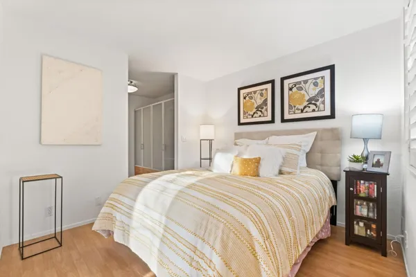 a bedroom with a bed and a mirror