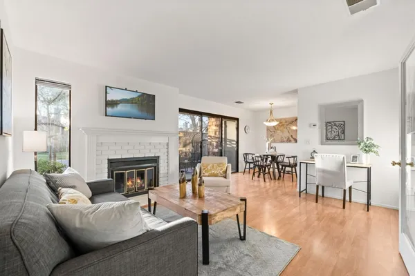 a living room with furniture a fireplace and a table