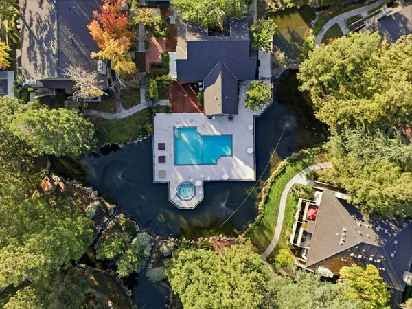 an aerial view of a house with swimming pool patio and outdoor seating