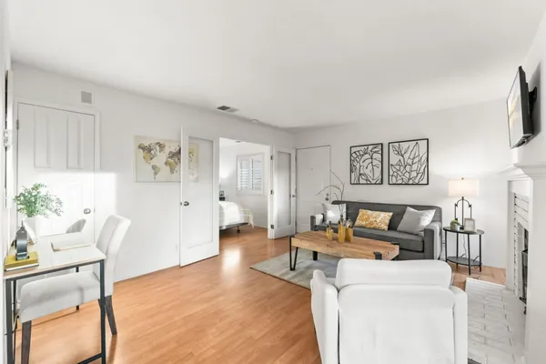 a living room with furniture and a wooden floor