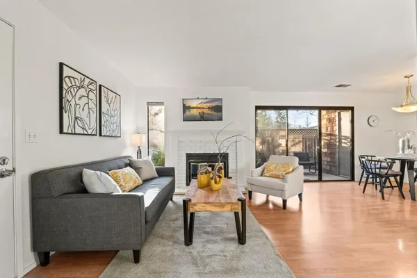 a living room with furniture a rug and a fireplace