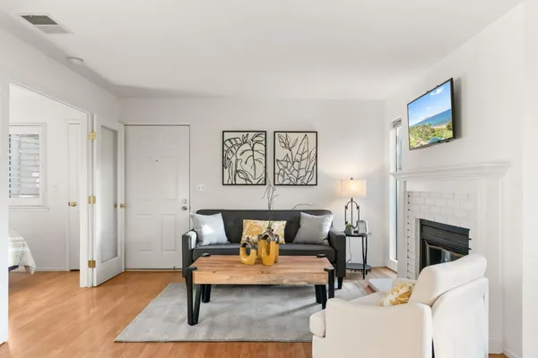 a living room with furniture and a fireplace