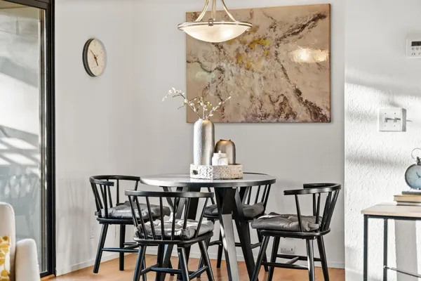 a view of a dining room with furniture and chandelier