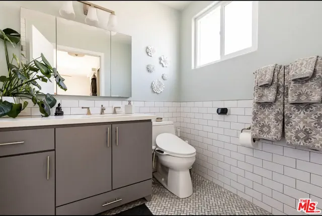 a bathroom with a sink toilet a mirror and shower