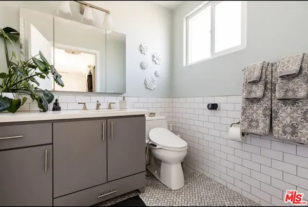a bathroom with a sink toilet a mirror and shower