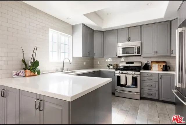 a kitchen with kitchen island white cabinets and white appliances