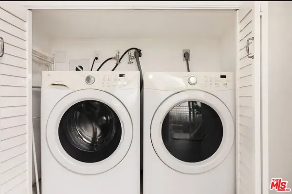 a view of a hallway with washer and dryer