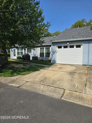 a front view of house with yard and trees