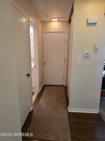 a view of hallway with wooden floor