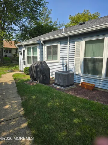 a backyard of a house with table and chairs