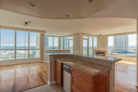 a view of a kitchen island wooden floor and living room