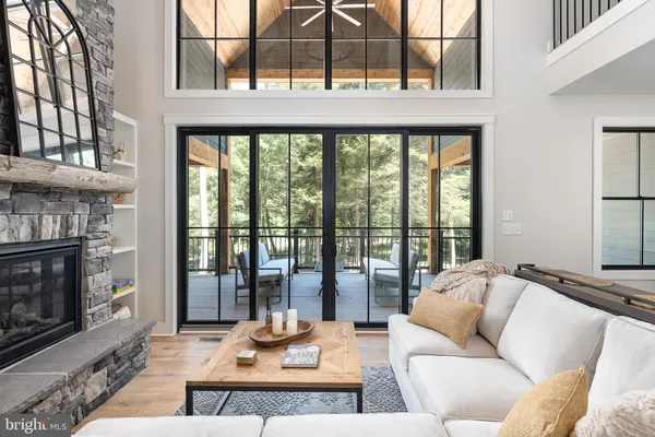 a kitchen with stainless steel appliances granite countertop a dining table chairs refrigerator and cabinets