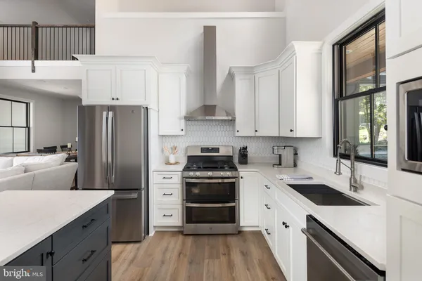 a bathroom with a granite countertop toilet a sink and a mirror