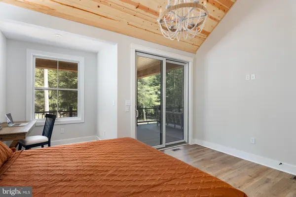 a bathroom with a granite countertop toilet sink and mirror